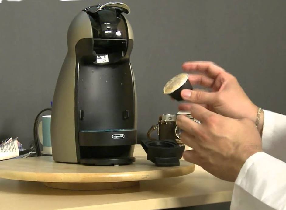 Scientist replacing a coffee pod in a coffee machine.